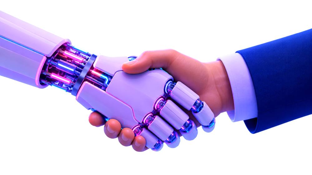 Robotic and human hands shaking — AI working alongside your team